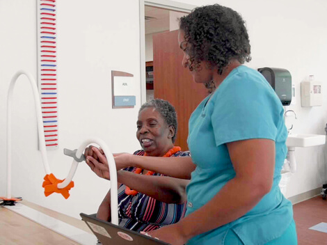 Therapist working with stroke rehabilitation patient.