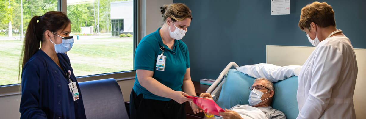 three nurses taking care of a patient